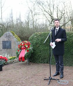 Auf dem Bild steht Jochen Engel am Mikrophon und hält eine Rede zum Gedenktag